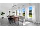 Bright dining room features a rustic wooden table and lake view at 20605 Preston Ln, Lutz, FL 33558