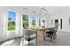 Bright dining room with large windows and a rustic wooden table at 20605 Preston Ln, Lutz, FL 33558