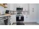 Modern kitchen featuring stainless steel appliances and ample cabinetry at 20605 Preston Ln, Lutz, FL 33558