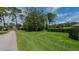 Vacant lot with grassy area and a tree-lined street at 20605 Preston Ln, Lutz, FL 33558