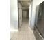 Clean hallway with light walls and tile flooring at 7634 Cortez Ct, Tampa, FL 33615