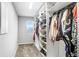 Large walk-in closet with custom shelving and hanging rods at 5472 Summer Sunset Dr, Apollo Beach, FL 33572