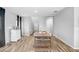 Dining area with a wood table and chairs near hallway entrance at 5472 Summer Sunset Dr, Apollo Beach, FL 33572