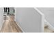 Long hallway with light wood flooring and staircase at 5472 Summer Sunset Dr, Apollo Beach, FL 33572