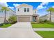 Two-story home with a neutral color palette and a two-car garage at 5472 Summer Sunset Dr, Apollo Beach, FL 33572