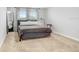 Comfortable bedroom with a gray bed and neutral wall decor at 5472 Summer Sunset Dr, Apollo Beach, FL 33572