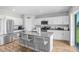 Modern kitchen with white cabinets, large island, and backyard access at 5472 Summer Sunset Dr, Apollo Beach, FL 33572