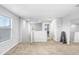 Open loft area with neutral decor, carpet flooring and a full-length mirror at 5472 Summer Sunset Dr, Apollo Beach, FL 33572