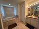 Primary bathroom features a soaking tub and double vanity at 6114 Nantucket Ln, Spring Hill, FL 34608