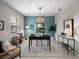 Home office with a teal accent wall and built-in shelving at 31417 Sun Kettle Loop, Wesley Chapel, FL 33545