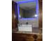 Modern bathroom with a lit mirror, undermount sink, and granite countertop at 9920 Eagles Point Cir # 2, Port Richey, FL 34668