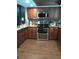 Kitchen with stainless steel appliances and wood cabinets at 9920 Eagles Point Cir # 2, Port Richey, FL 34668