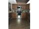 Well-equipped kitchen featuring stainless steel appliances and dark wood cabinetry at 9920 Eagles Point Cir # 2, Port Richey, FL 34668