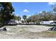 A vacant lot is ready for development with a mix of sandy soil and sprouting grass at 210 E Janette Ave, Tampa, FL 33603