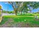 Spacious backyard with green grass, trees, and a water hookup at 21415 Hopson Rd, Land O Lakes, FL 34638