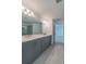 Primary bathroom boasts dual sinks, grey cabinetry, quartz countertop and walk-in glass shower at 3204 N Morgan St, Tampa, FL 33603