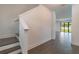 Bright entryway featuring hardwood floors, a staircase, and views of the living area and the backyard at 3204 N Morgan St, Tampa, FL 33603