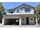 Under-construction two-story home featuring a large garage and visible framework, set against a clear blue sky at 3204 N Morgan St, Tampa, FL 33603