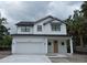 Charming new construction home with two stories, a garage, and a covered front porch at 3204 N Morgan St, Tampa, FL 33603