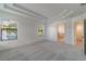 Bright main bedroom with tray ceilings, large windows, and access to the bathroom and walk-in closet at 3204 N Morgan St, Tampa, FL 33603