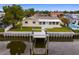 Aerial view of a single-story home with a private dock and canal access at 8716 Elmwood Ln, Tampa, FL 33615