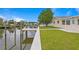 Landscaped backyard with canal access and a dock at 8716 Elmwood Ln, Tampa, FL 33615