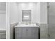 Modern bathroom with gray vanity and walk-in shower at 8716 Elmwood Ln, Tampa, FL 33615
