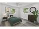 Cozy bedroom with modern decor, including a comfortable bed, sleek dresser, and plenty of natural light at 8716 Elmwood Ln, Tampa, FL 33615
