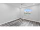 Bright bedroom with wood-look floors and a ceiling fan at 8716 Elmwood Ln, Tampa, FL 33615