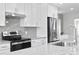 Sleek kitchen featuring stainless steel appliances and granite countertops at 8716 Elmwood Ln, Tampa, FL 33615
