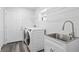 Convenient laundry room with washer, dryer, and utility sink at 8716 Elmwood Ln, Tampa, FL 33615