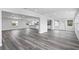 Open living area with grey wood-look flooring and recessed lighting at 8716 Elmwood Ln, Tampa, FL 33615