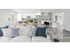 Living room with white sofa and adjacent kitchen with breakfast bar at 8716 Elmwood Ln, Tampa, FL 33615