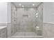 Large walk-in shower with gray tile and built-in seat at 8716 Elmwood Ln, Tampa, FL 33615