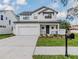 Two-story farmhouse style home with white siding and a dark metal roof at 3204 N Morgan St, Tampa, FL 33603