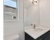 Bright bathroom featuring a vanity with a quartz countertop and a large mirror at 210 E Janette Ave, Tampa, FL 33603