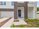 Modern home's front entrance with blue door and landscaping at 210 E Janette Ave, Tampa, FL 33603