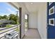 Private balcony with blue door and a view of the street at 210 E Janette Ave, Tampa, FL 33603