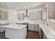 Modern kitchen island with white quartz countertop and gray cabinets at 210 E Janette Ave, Tampa, FL 33603