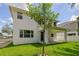 Two-story house with a covered patio and a well-manicured lawn at 210 E Janette Ave, Tampa, FL 33603