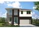 Modern two-story home with attached garage and landscaping at 210 E Janette Ave, Tampa, FL 33603