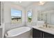 Bathroom with large bathtub and marble tile at 210 E Janette Ave, Tampa, FL 33603