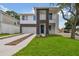Two-story modern home with driveway and landscaped lawn at 210 E Janette Ave, Tampa, FL 33603