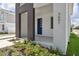 Modern home's front entrance with blue door and landscaping at 210 E Janette Ave, Tampa, FL 33603