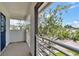 Balcony view features a tree-lined street and neighborhood homes at 210 E Janette Ave, Tampa, FL 33603