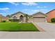 Tan one-story house with two-car garage at 19148 Dove Creek Dr, Tampa, FL 33647
