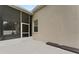 View of home's backyard with screened porch and patio at 19148 Dove Creek Dr, Tampa, FL 33647