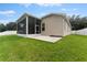 Home's exterior showcasing a large backyard and screened porch at 19148 Dove Creek Dr, Tampa, FL 33647