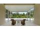 Screened porch with wicker chairs and tranquil view at 19148 Dove Creek Dr, Tampa, FL 33647