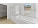 Bathroom with soaking tub and walk-in shower, plus a window at 19148 Dove Creek Dr, Tampa, FL 33647